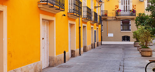 a hallway with a beautiful yellow painted buildings