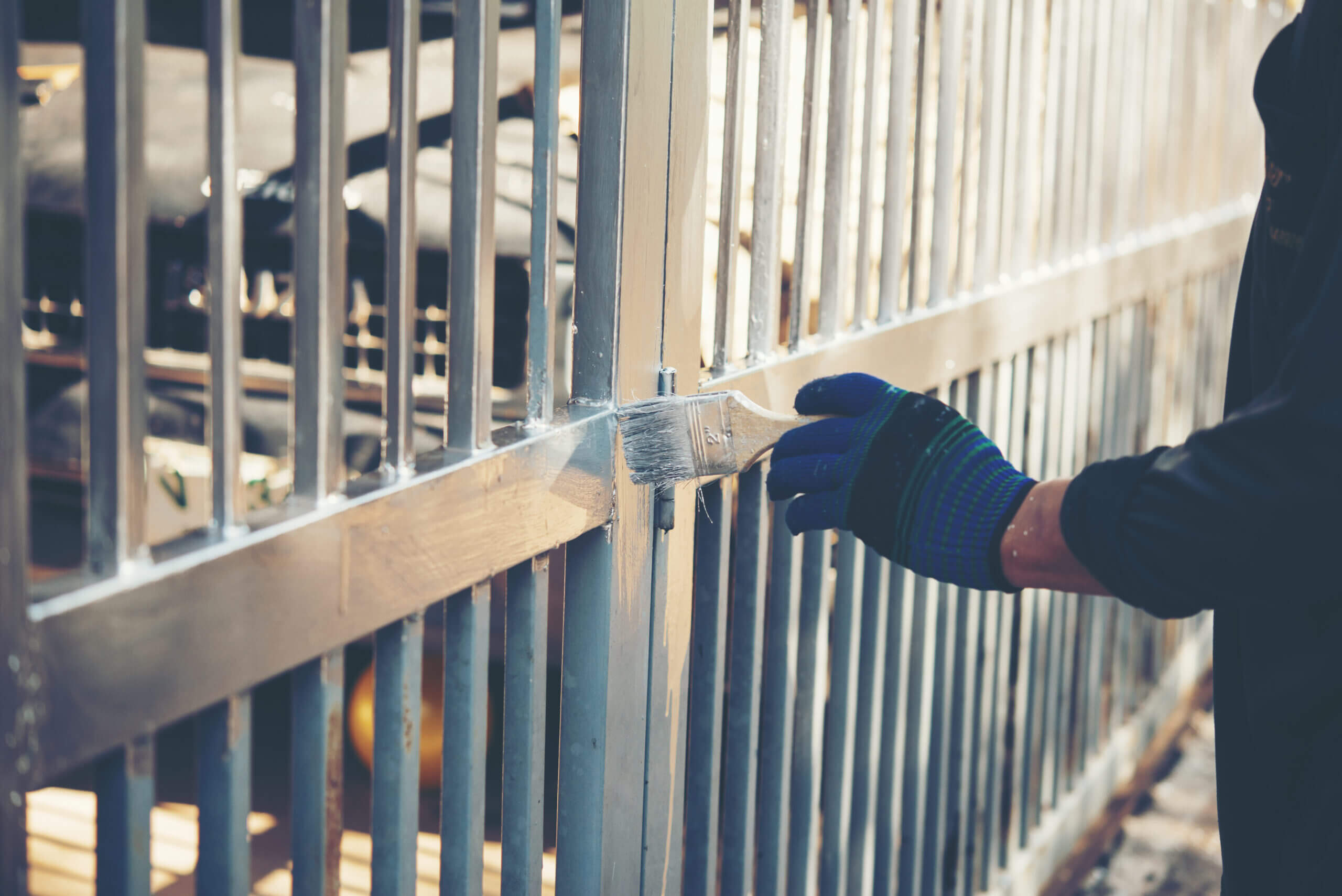construction worker painting fence home