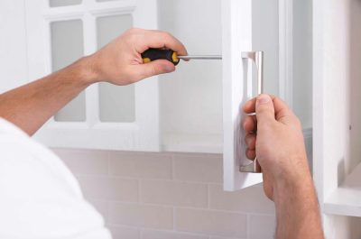 homeguide-handyman-installing-new-cabinet-hardware homeguide-handyman-installing-new-cabinet-hardware